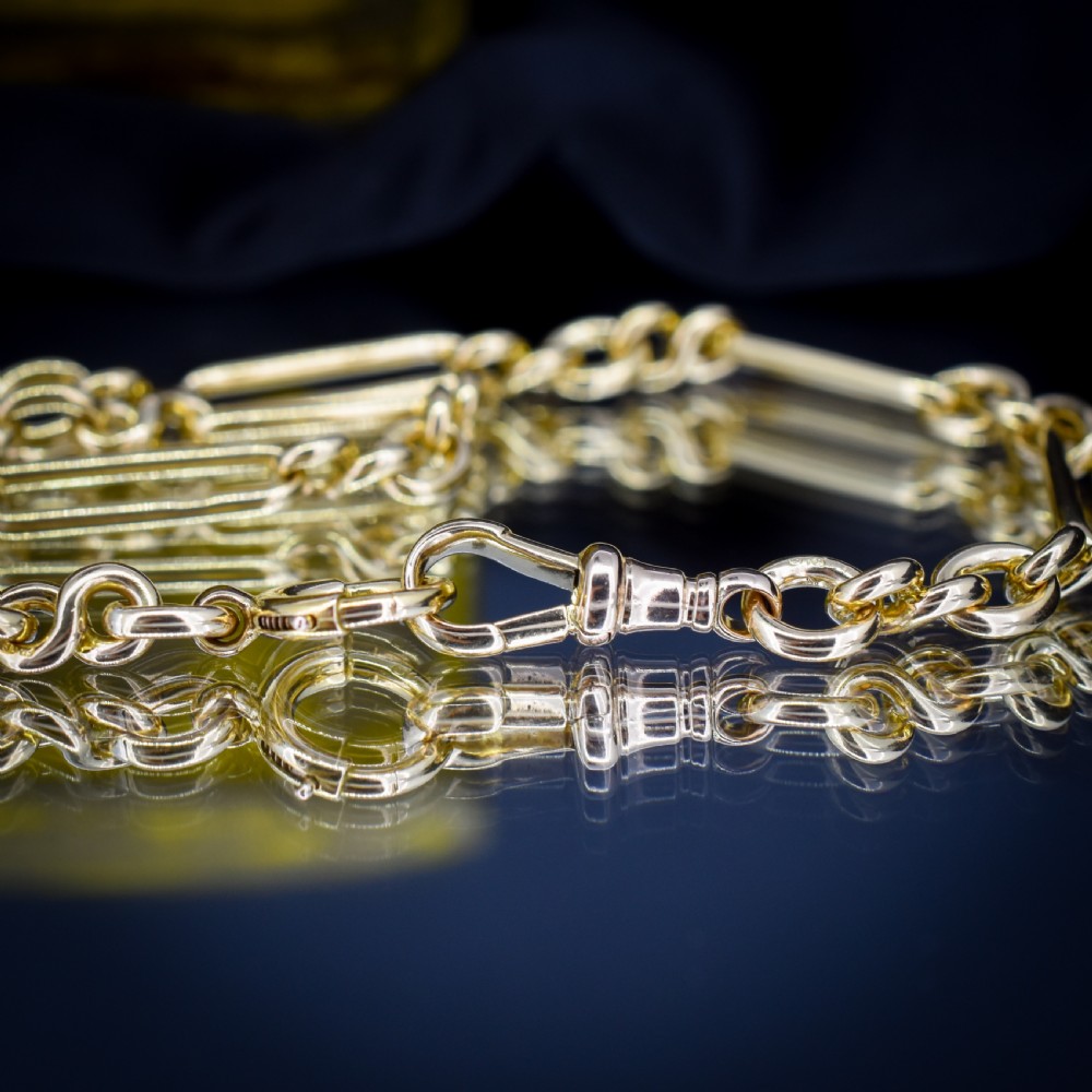 An antique 18ct yellow gold trombone link watch chain featuring an integrated T-bar and swivel clasp fastener. View VI