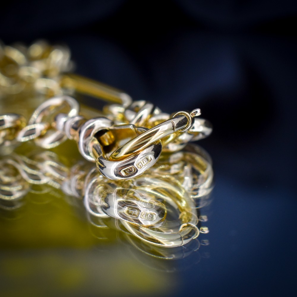 An antique 18ct yellow gold trombone link watch chain featuring an integrated T-bar and swivel clasp fastener. View VII