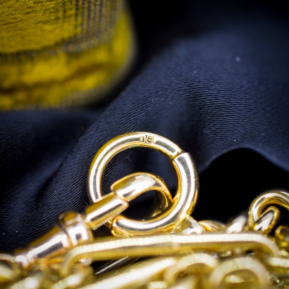 An antique 18ct yellow gold trombone link watch chain featuring an integrated T-bar and swivel clasp fastener. View VIII