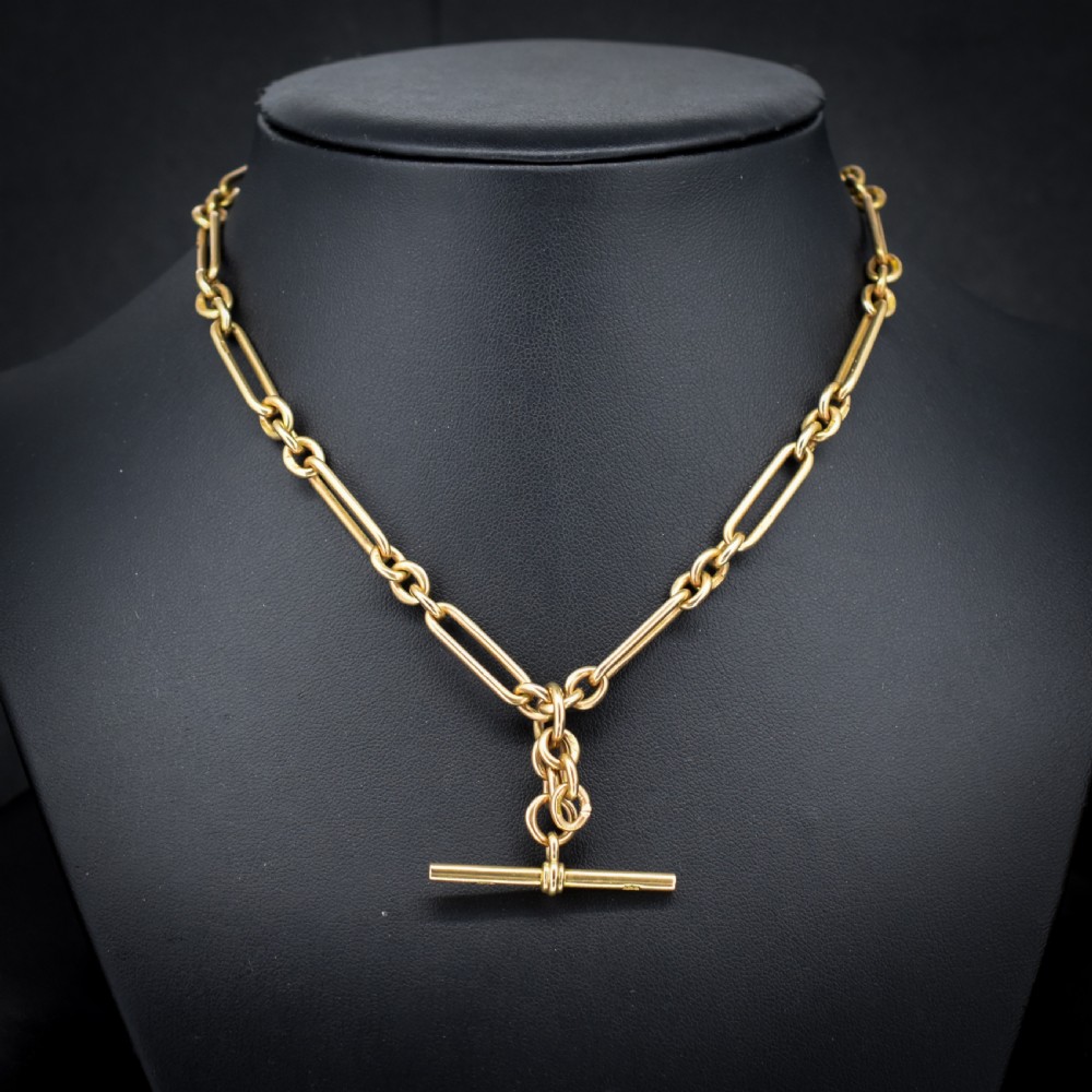 A 9ct yellow gold Art Deco Albert watch chain featuring alternating elongated trombone links, a swivel clasp, and a T-bar. View III