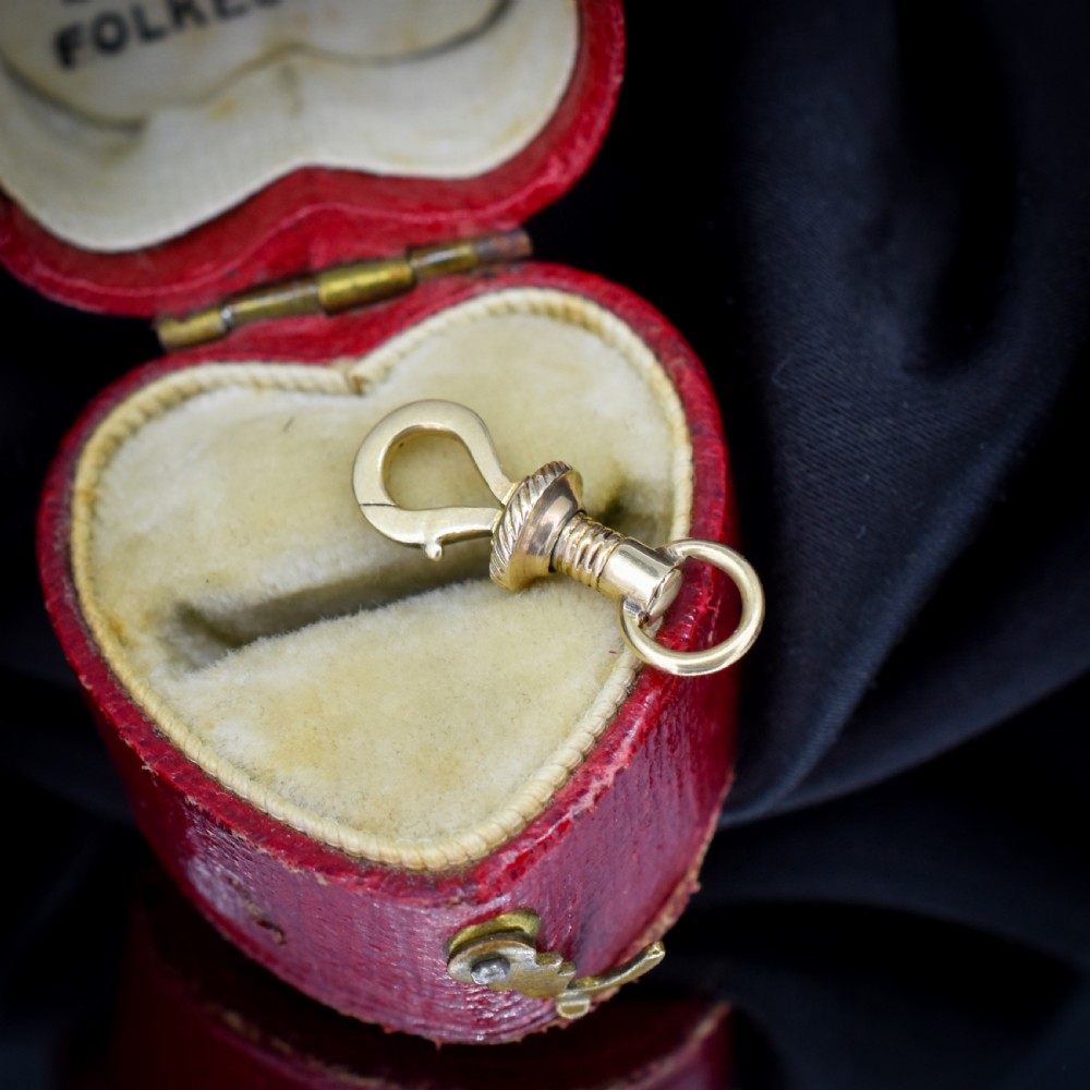 An antique 12ct yellow gold dog clip fastener with a textured screw collar mechanism and top swivel ring. View II