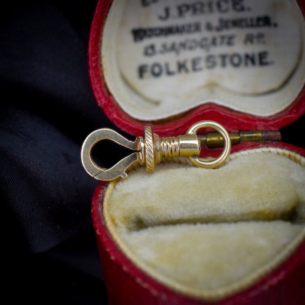 An antique 12ct yellow gold dog clip fastener with a textured screw collar mechanism and top swivel ring. View III