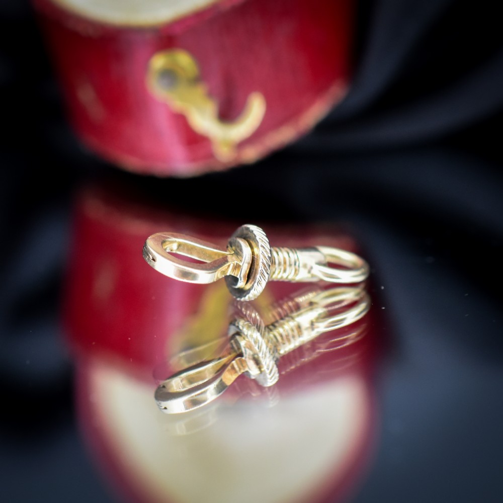 An antique 12ct yellow gold dog clip fastener with a textured screw collar mechanism and top swivel ring. View VI
