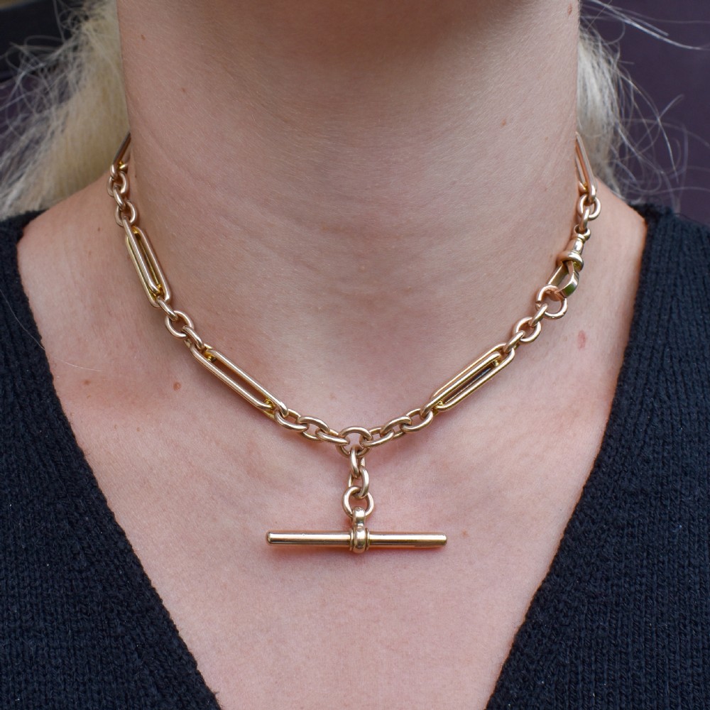 A 10ct yellow gold Albert chain with alternating trombone and oval links, complete with a T-bar and swivel clasp. View II