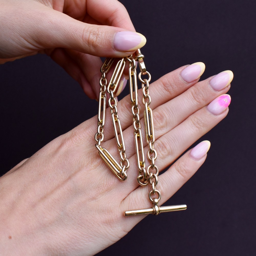 A 10ct yellow gold Albert chain with alternating trombone and oval links, complete with a T-bar and swivel clasp. View III