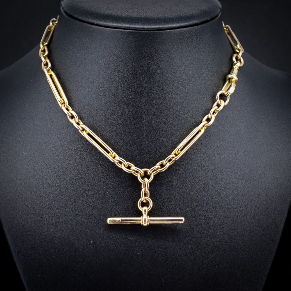 A 10ct yellow gold Albert chain with alternating trombone and oval links, complete with a T-bar and swivel clasp. View IV