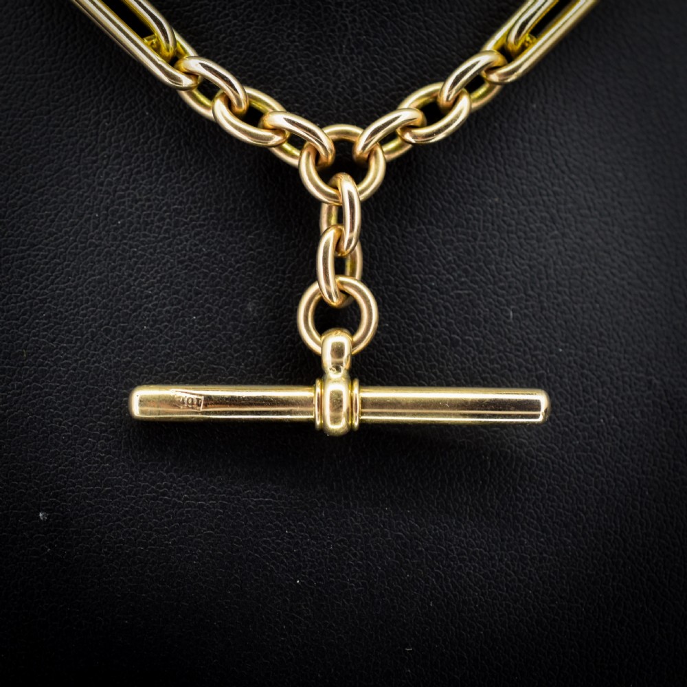A 10ct yellow gold Albert chain with alternating trombone and oval links, complete with a T-bar and swivel clasp. View V