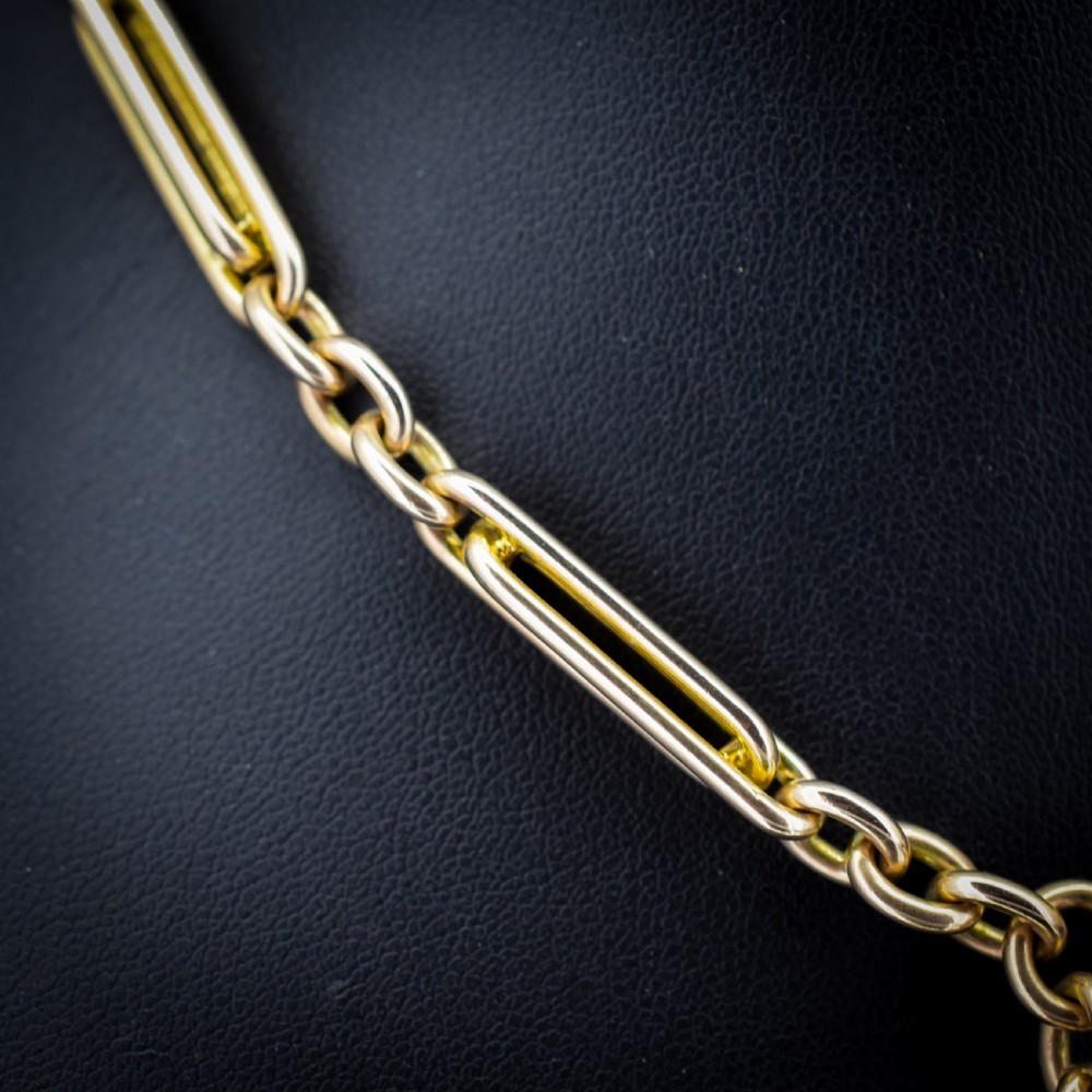 A 10ct yellow gold Albert chain with alternating trombone and oval links, complete with a T-bar and swivel clasp. View VI