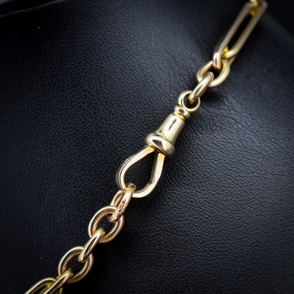 A 10ct yellow gold Albert chain with alternating trombone and oval links, complete with a T-bar and swivel clasp. View VIII
