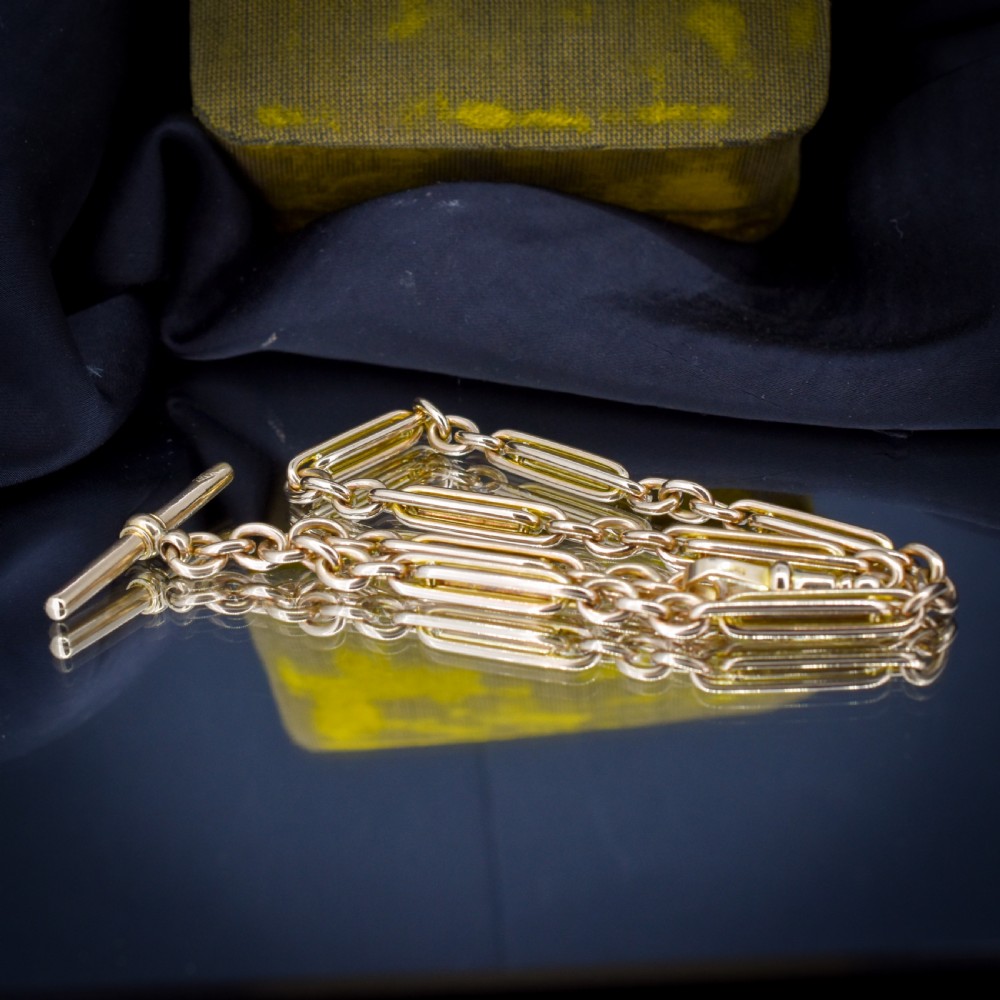 A 10ct yellow gold Albert chain with alternating trombone and oval links, complete with a T-bar and swivel clasp. View X
