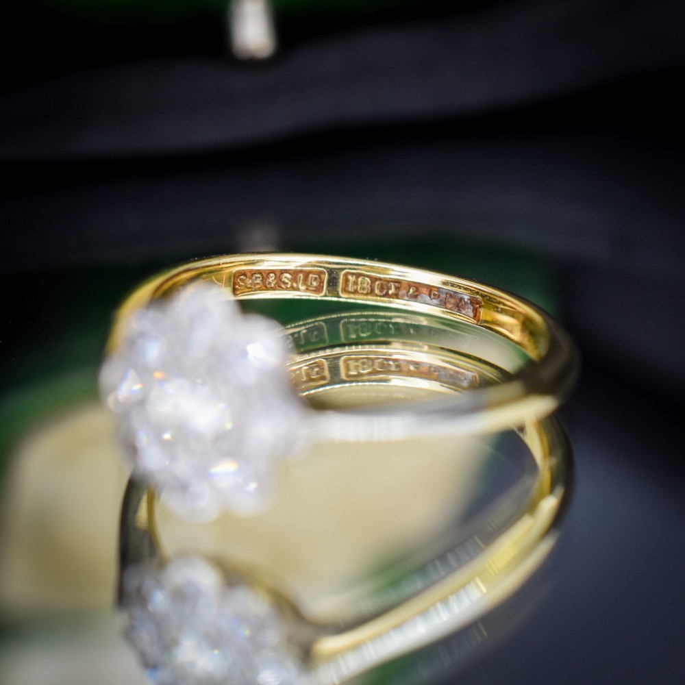 An antique diamond cluster ring arranged in a floral daisy pattern, set in platinum with an 18ct yellow gold band. View VIII