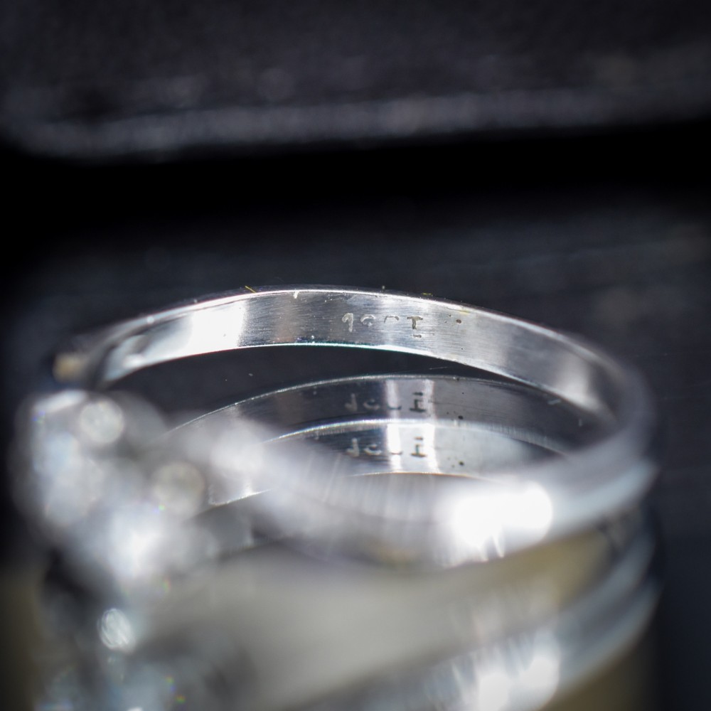 An antique 18ct white gold Toi et Moi ring featuring two central round diamonds set in a diagonal twist arrangement with diamond-set shoulders. View VII