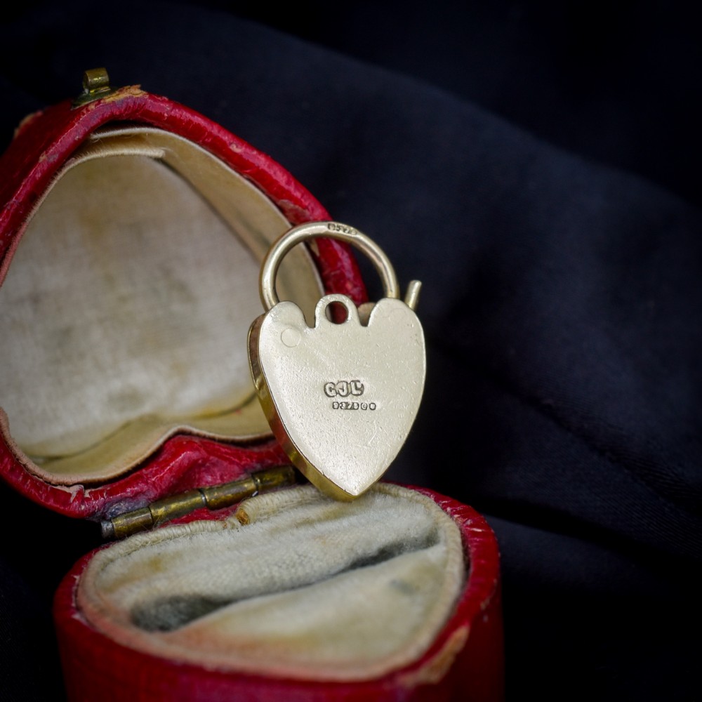 A 9ct yellow gold heart-shaped padlock charm featuring hand-engraved scrollwork and a keyhole detail. View II