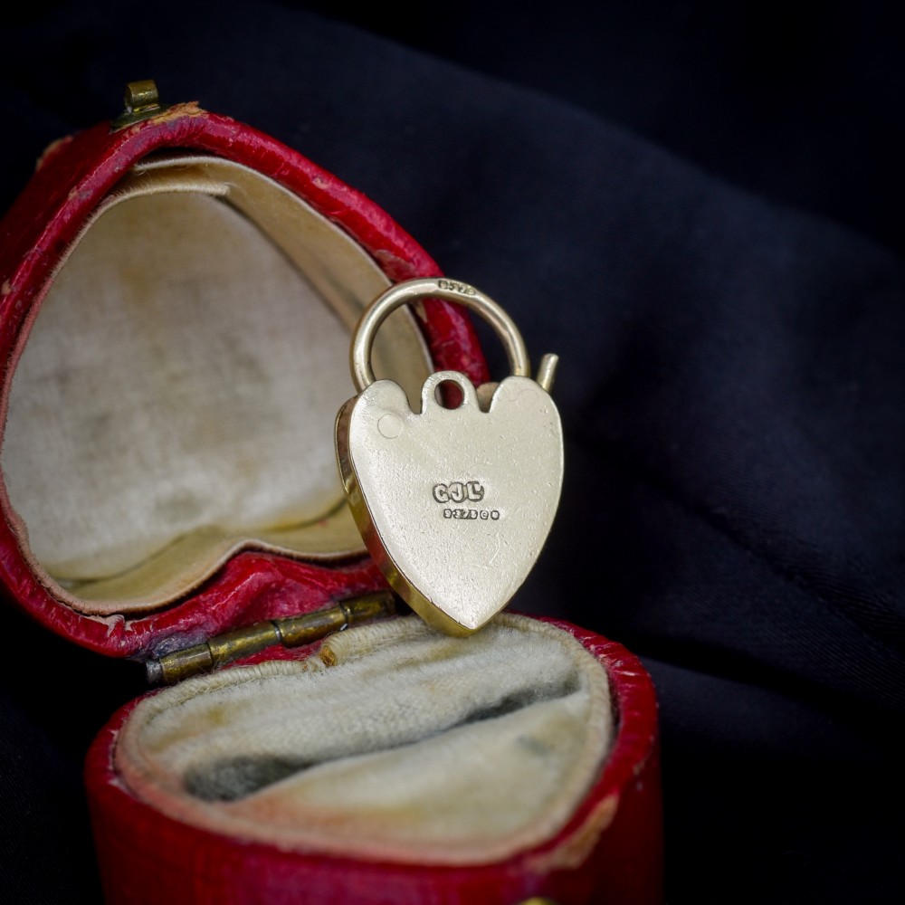A 9ct yellow gold heart-shaped padlock charm featuring hand-engraved scrollwork and a keyhole detail. View III