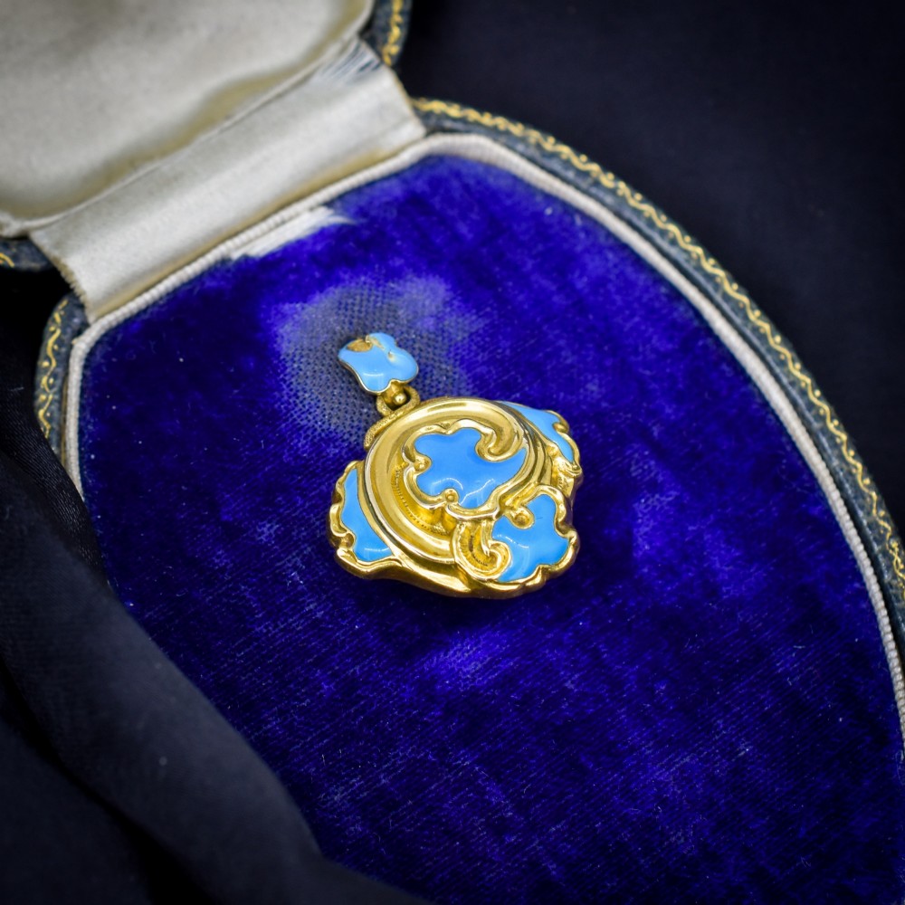 An antique 18ct yellow gold pendant featuring swirling scrollwork inlaid with vibrant turquoise blue enamel. View II