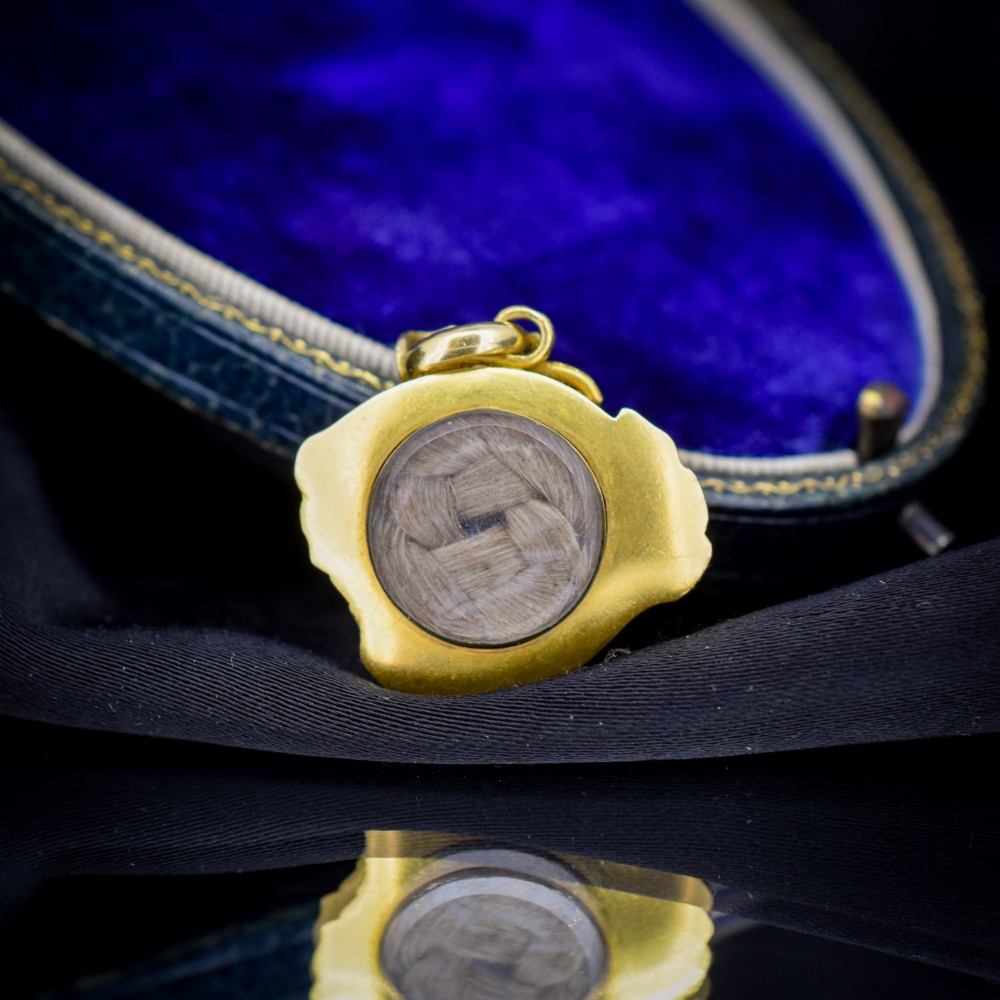 An antique 18ct yellow gold pendant featuring swirling scrollwork inlaid with vibrant turquoise blue enamel. View III