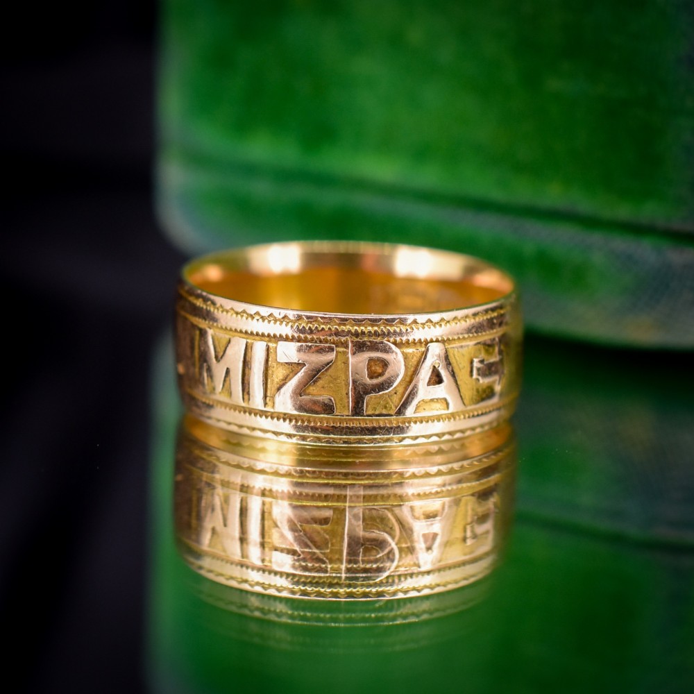 An antique 18ct yellow gold wide band ring featuring the word MIZPAH in raised relief lettering bordered by beaded detailing. View IV
