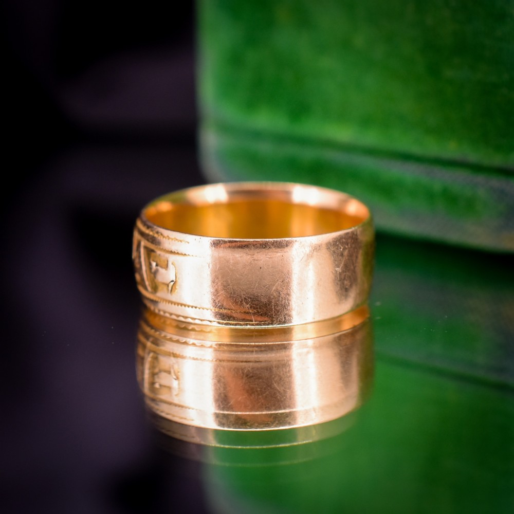An antique 18ct yellow gold wide band ring featuring the word MIZPAH in raised relief lettering bordered by beaded detailing. View VII