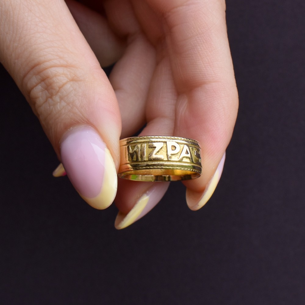 An antique 18ct yellow gold wide band ring featuring the word MIZPAH in raised relief lettering bordered by beaded detailing. View X