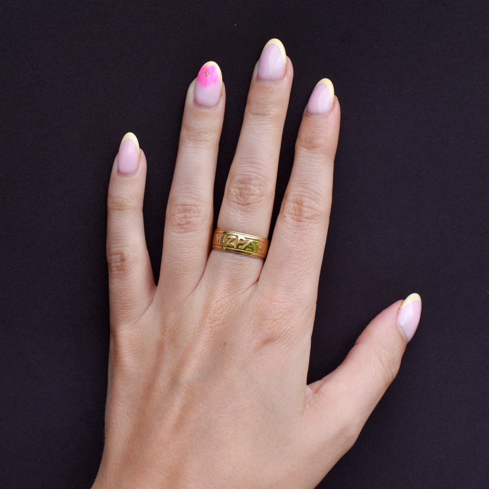 An antique 18ct yellow gold wide band ring featuring the word MIZPAH in raised relief lettering bordered by beaded detailing. View XI