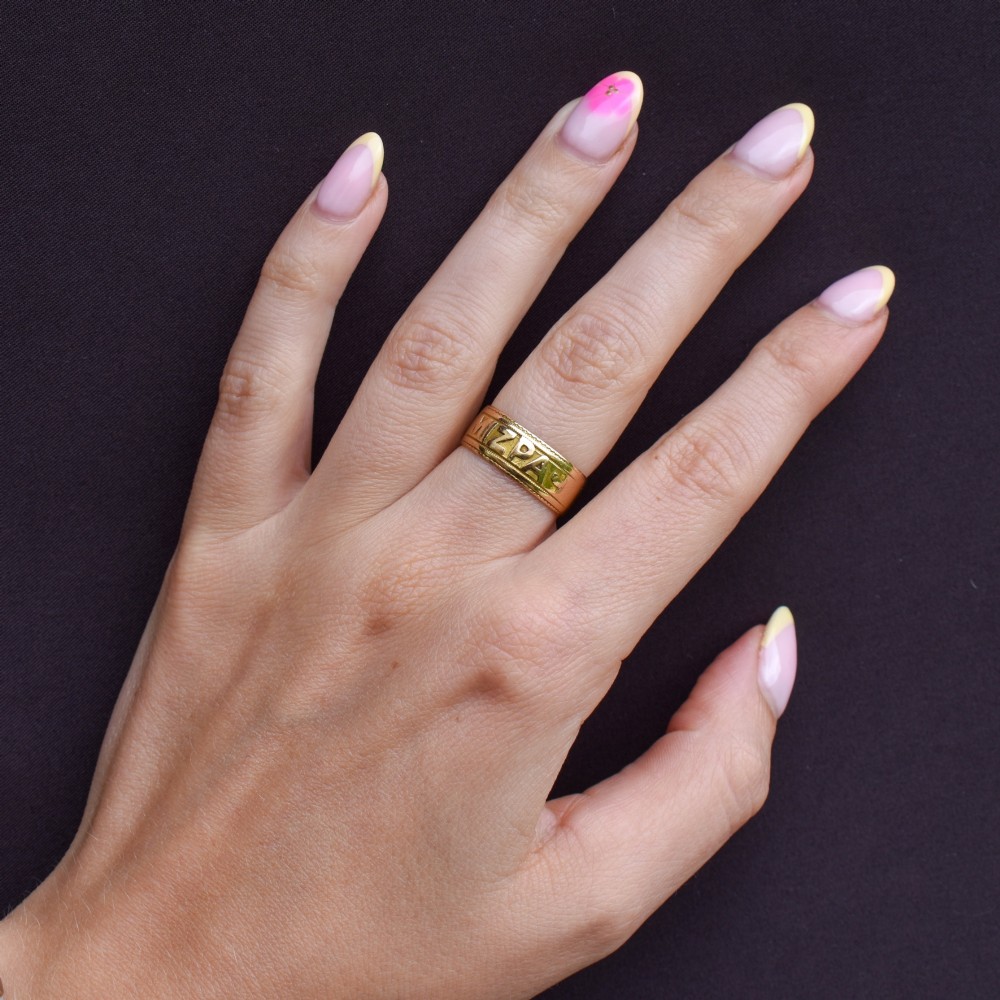 An antique 18ct yellow gold wide band ring featuring the word MIZPAH in raised relief lettering bordered by beaded detailing. View XII