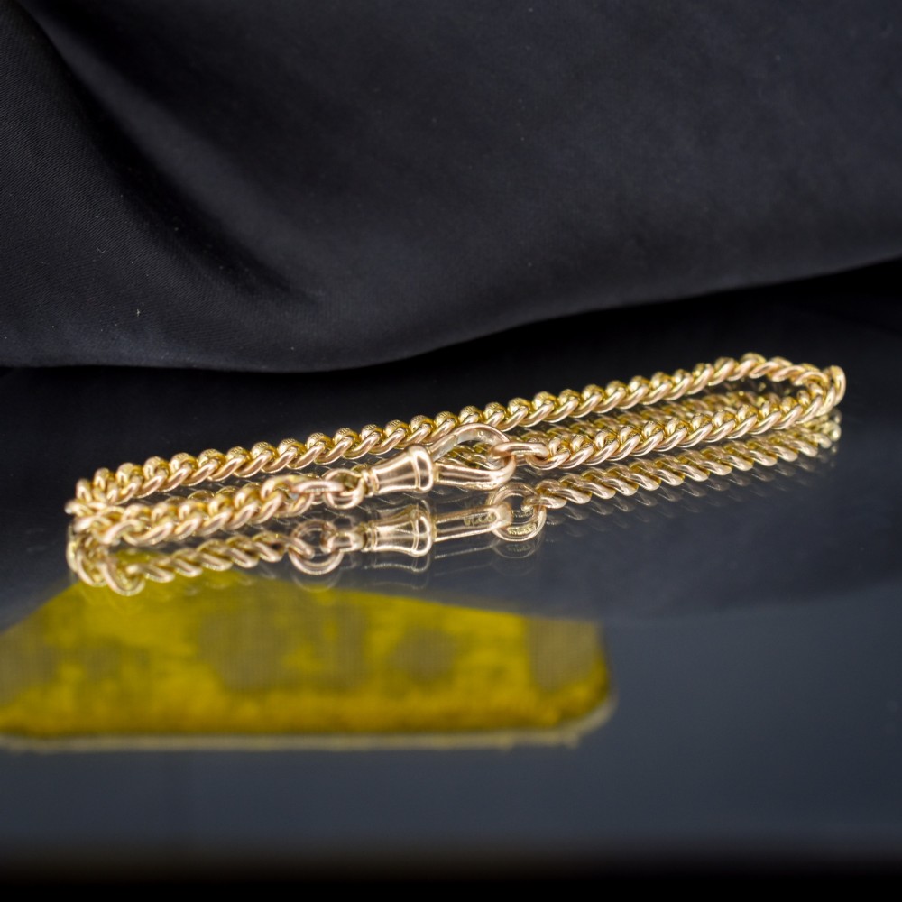 An antique 9ct yellow gold curb link chain bracelet fitted with a dog clip swivel clasp. View II