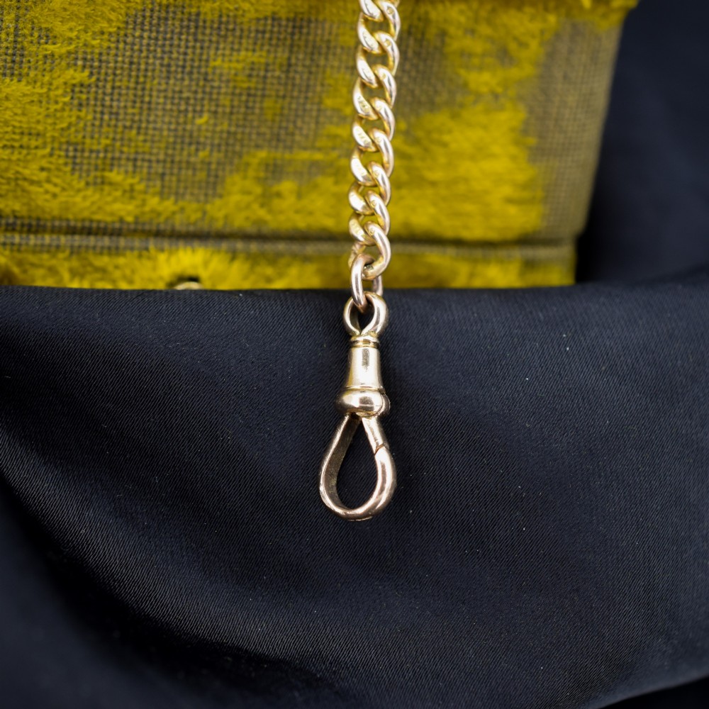 An antique 9ct yellow gold curb link chain bracelet fitted with a dog clip swivel clasp. View VI