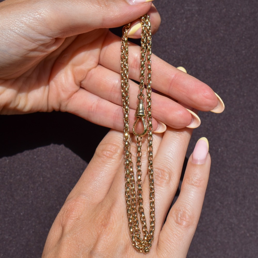 An antique Victorian 9ct yellow gold chain necklace with faceted circular links and a dog clip clasp. View IX