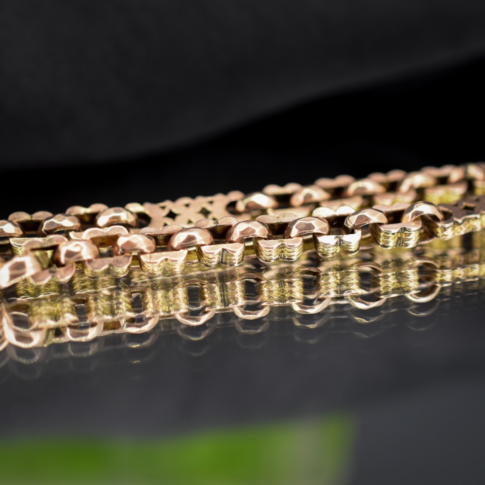 An antique 9ct yellow gold fancy link chain bracelet with a swivel clasp and suspended T-bar element. View III