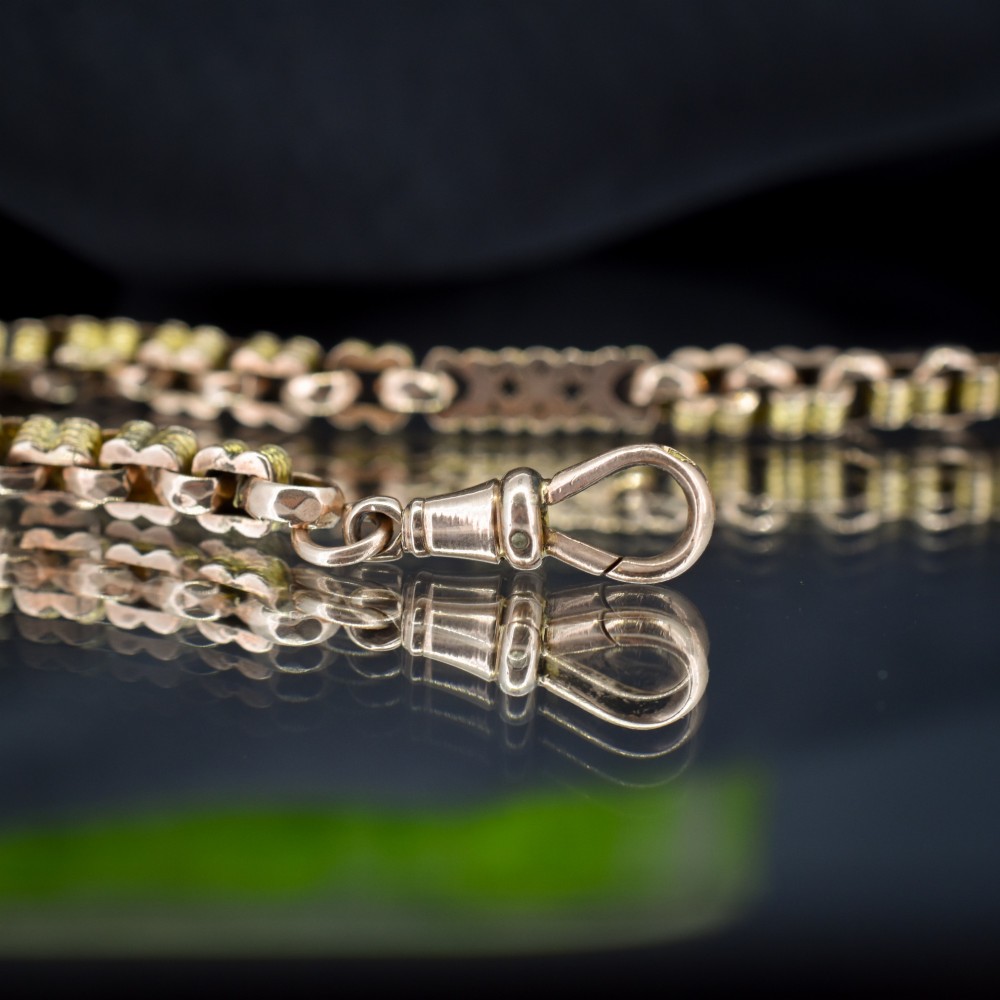 An antique 9ct yellow gold fancy link chain bracelet with a swivel clasp and suspended T-bar element. View V