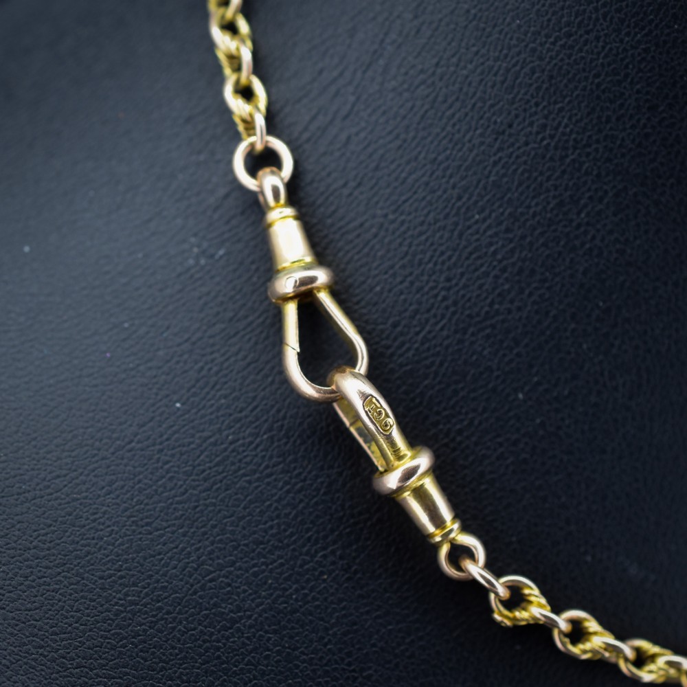 An antique 9ct gold double Albert watch chain featuring love knot links, two swivel clasps, and a central T-bar. View III