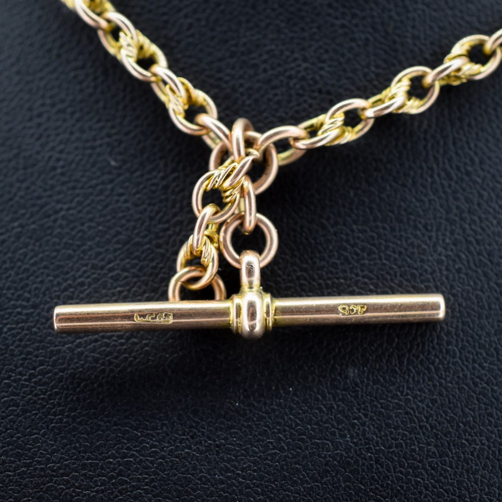 An antique 9ct gold double Albert watch chain featuring love knot links, two swivel clasps, and a central T-bar. View IV