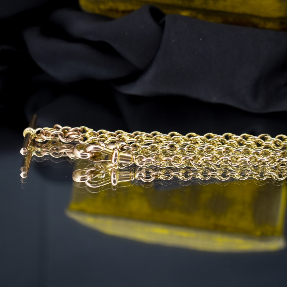An antique 9ct gold double Albert watch chain featuring love knot links, two swivel clasps, and a central T-bar. View VI