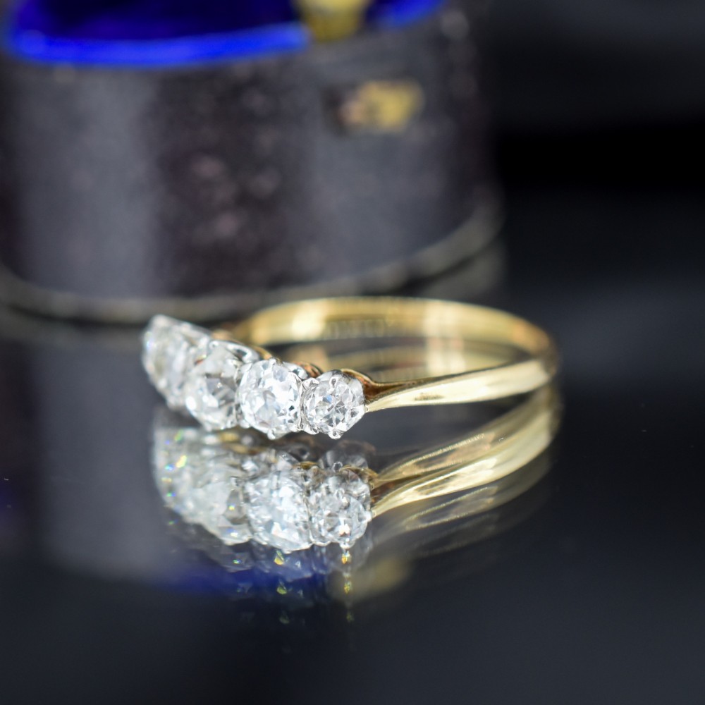 An antique five-stone ring featuring five graduated old cut diamonds set in a row mounted on a gold band. View VII