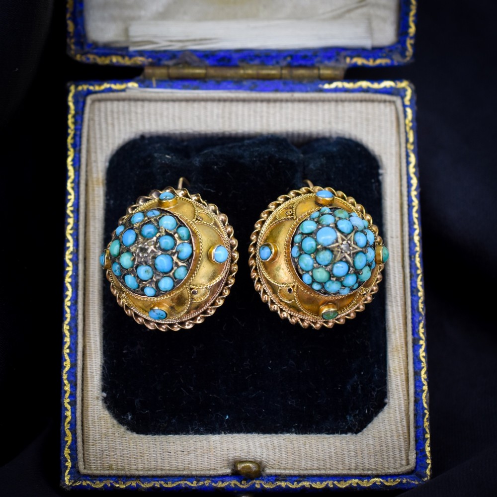 A pair of circular Victorian 9ct gold earrings featuring raised central domes set with pave turquoise cabochons and framed by decorative wirework.