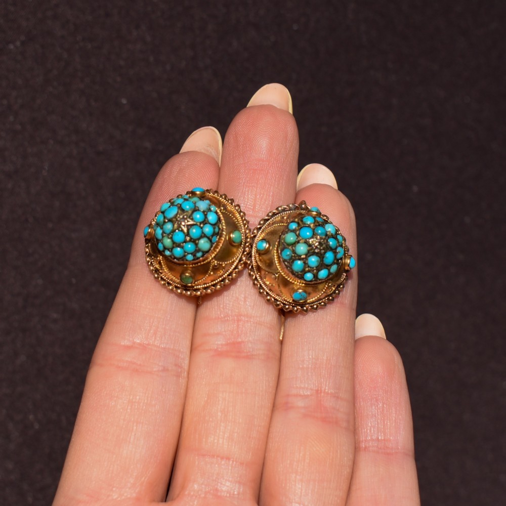 A pair of circular Victorian 9ct gold earrings featuring raised central domes set with pave turquoise cabochons and framed by decorative wirework. View VII