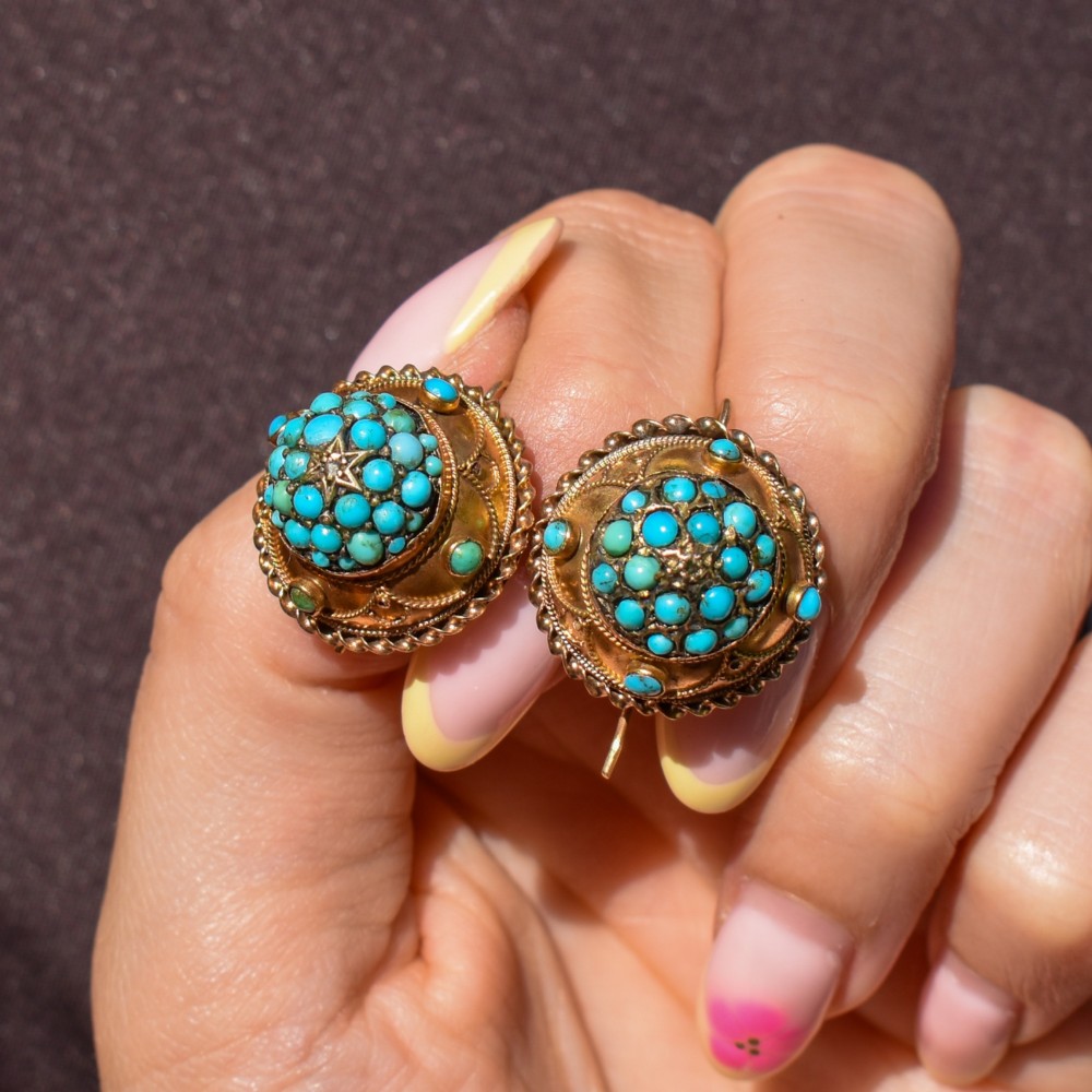 A pair of circular Victorian 9ct gold earrings featuring raised central domes set with pave turquoise cabochons and framed by decorative wirework. View IX