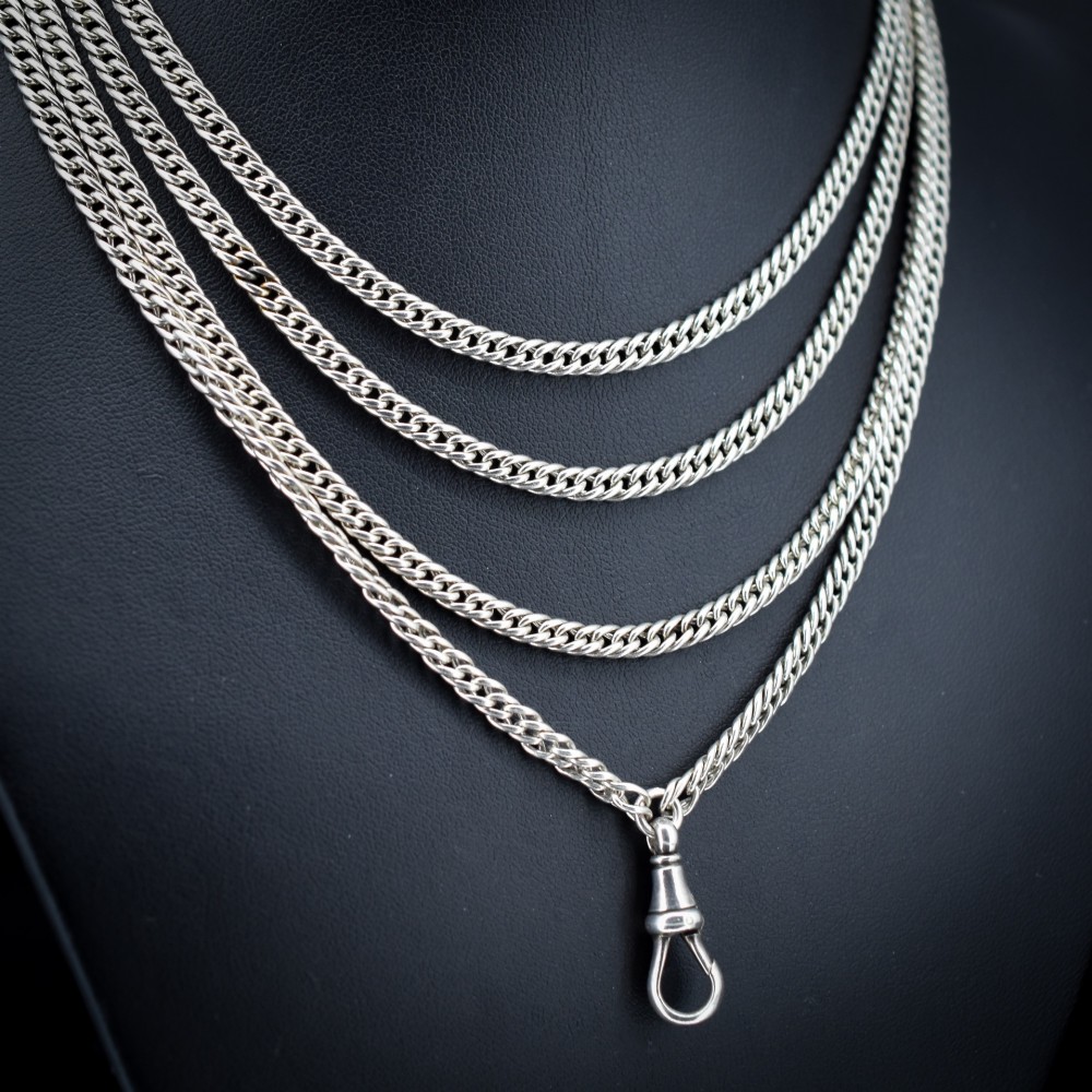 A long sterling silver flat curb link guard chain draped in multiple tiers with a dog clip clasp at the bottom. View II