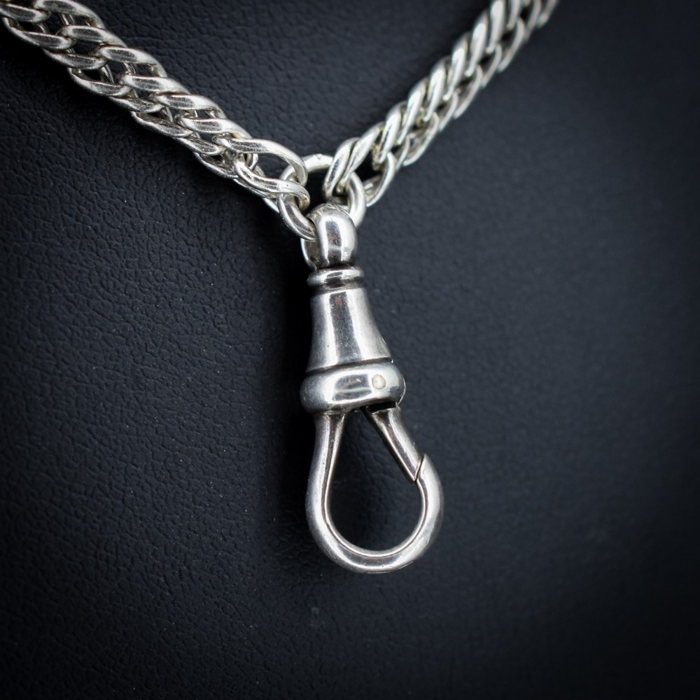 A long sterling silver flat curb link guard chain draped in multiple tiers with a dog clip clasp at the bottom. View III