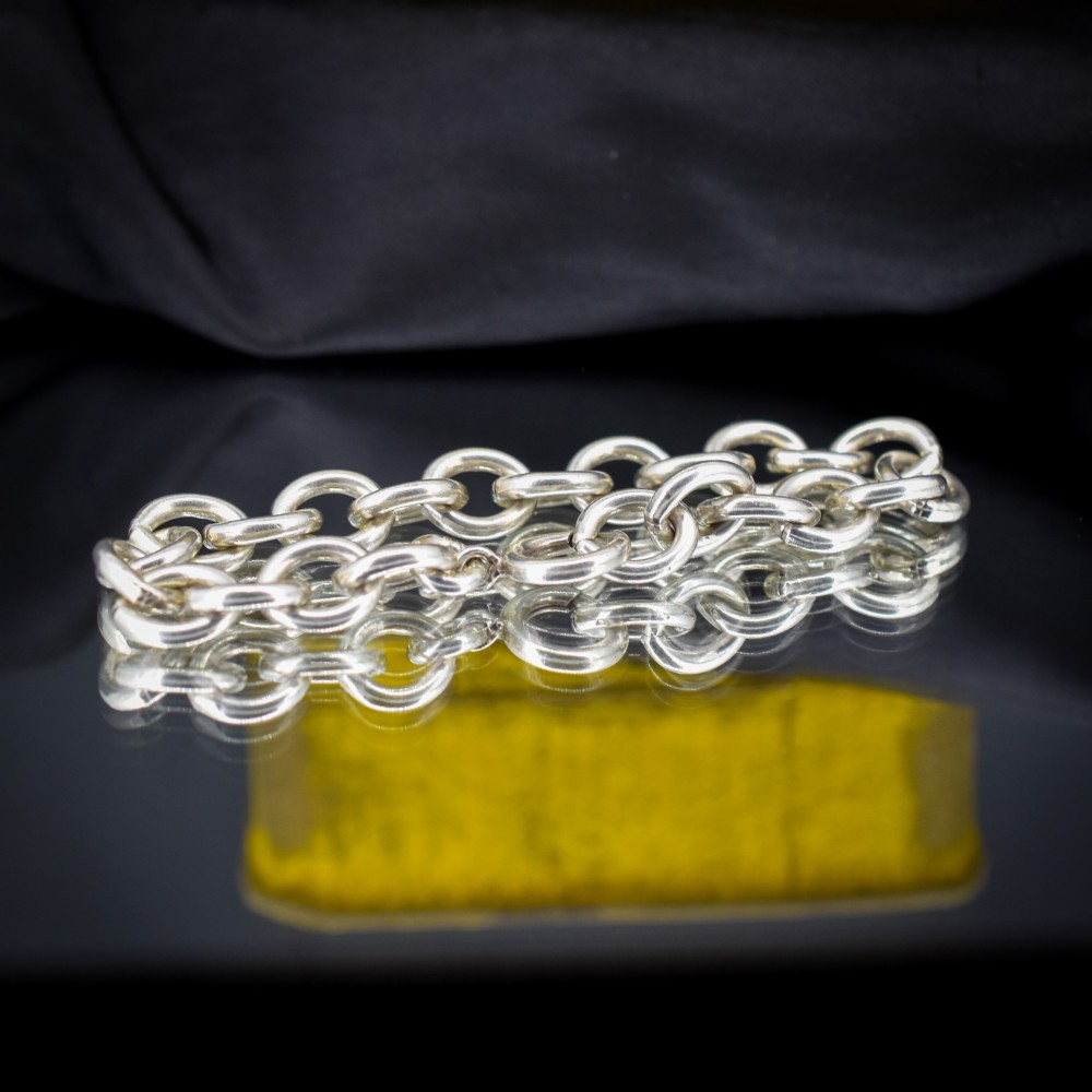 A sterling silver link bracelet composed of interlocking oval cable links with a bolt ring clasp. View II