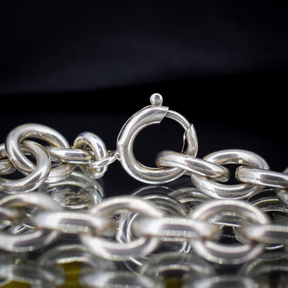 A sterling silver link bracelet composed of interlocking oval cable links with a bolt ring clasp. View III