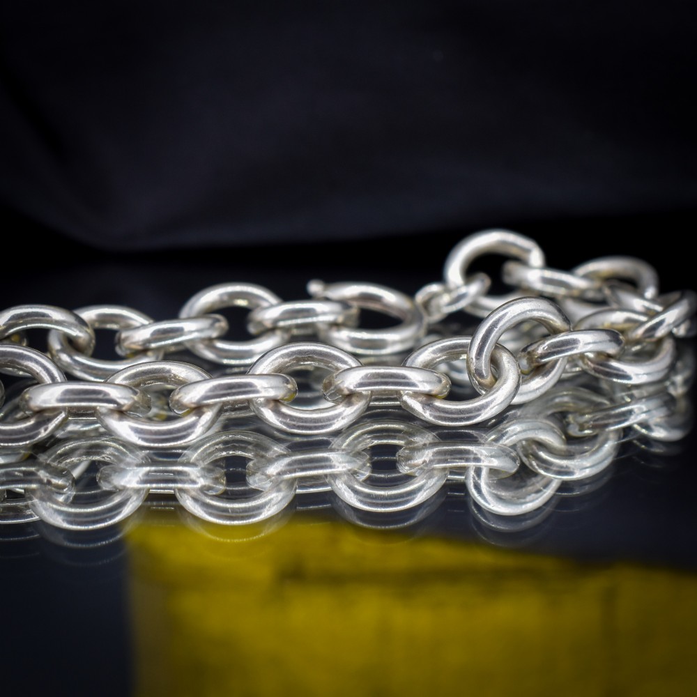 A sterling silver link bracelet composed of interlocking oval cable links with a bolt ring clasp. View IV