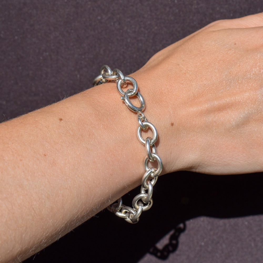 A sterling silver link bracelet composed of interlocking oval cable links with a bolt ring clasp. View VIII