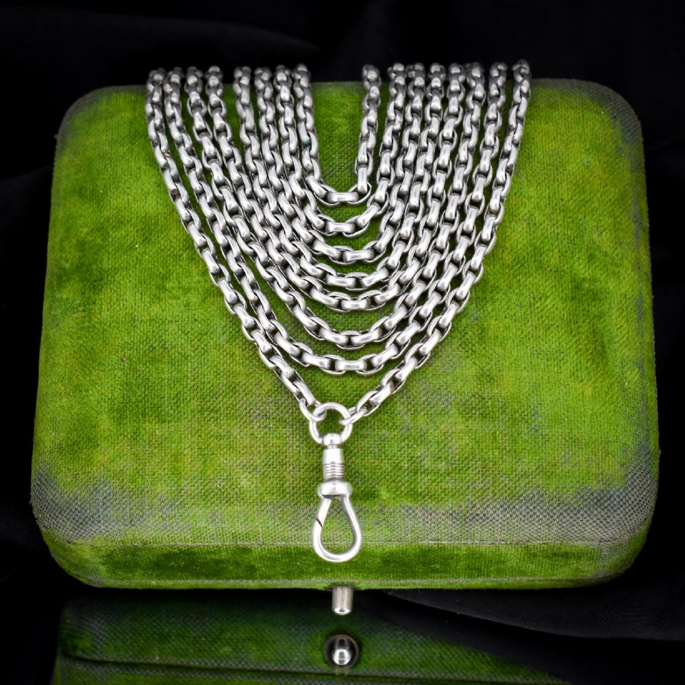 A long silver guard chain necklace constructed with interlocking round links and fitted with a dog clip swivel clasp. View III