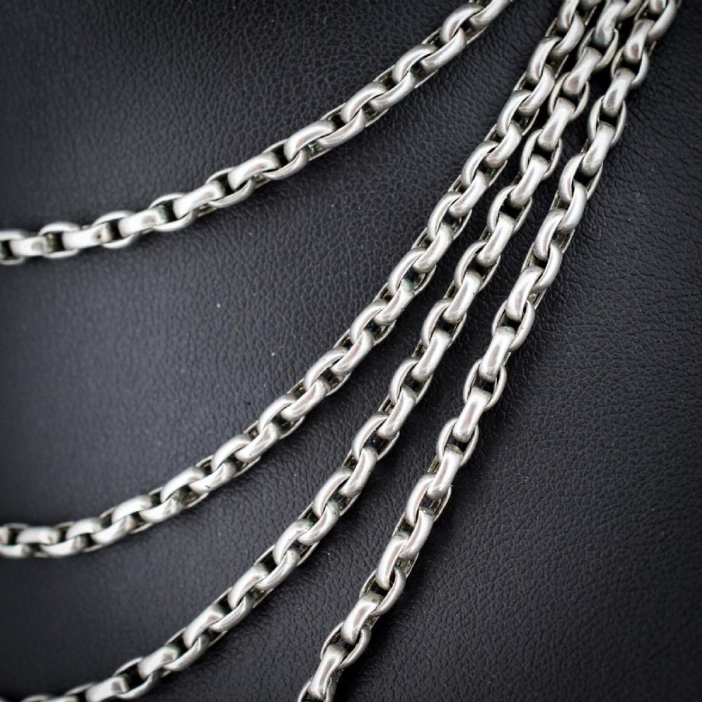 A long silver guard chain necklace constructed with interlocking round links and fitted with a dog clip swivel clasp. View IV