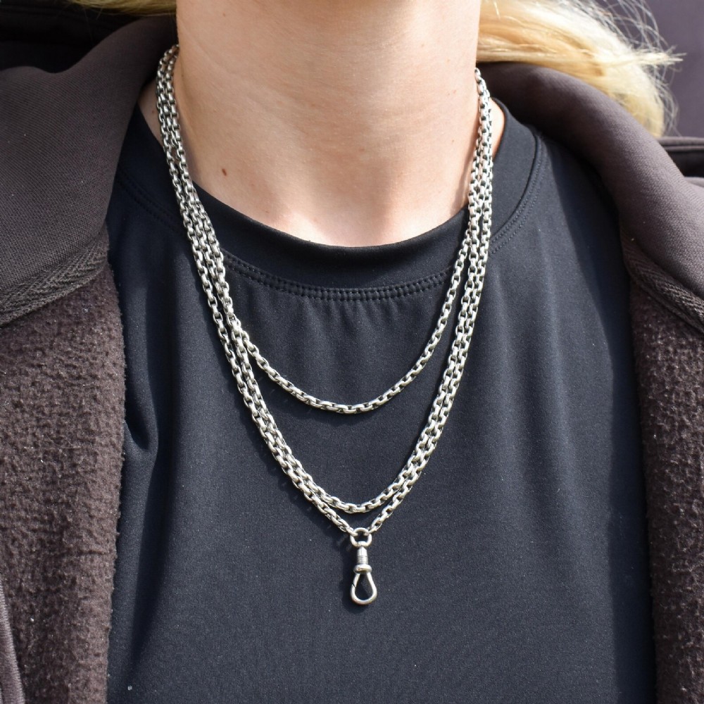 A long silver guard chain necklace constructed with interlocking round links and fitted with a dog clip swivel clasp. View VI
