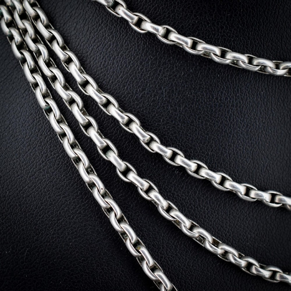 A long silver guard chain necklace constructed with interlocking round links and fitted with a dog clip swivel clasp. View VIII