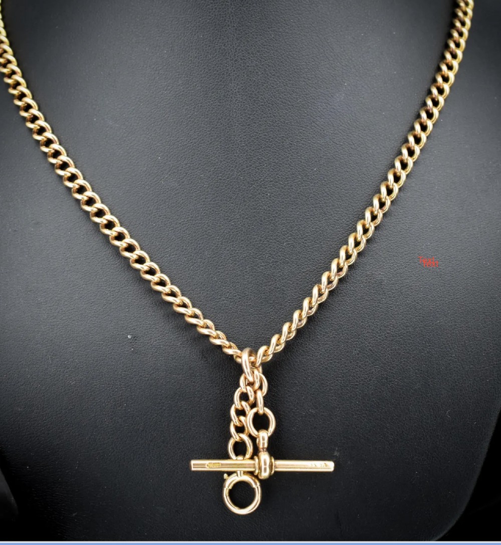 An antique 15ct yellow gold Albert chain necklace featuring curb links, a T-bar drop, a bolt ring, and a dog clip clasp.