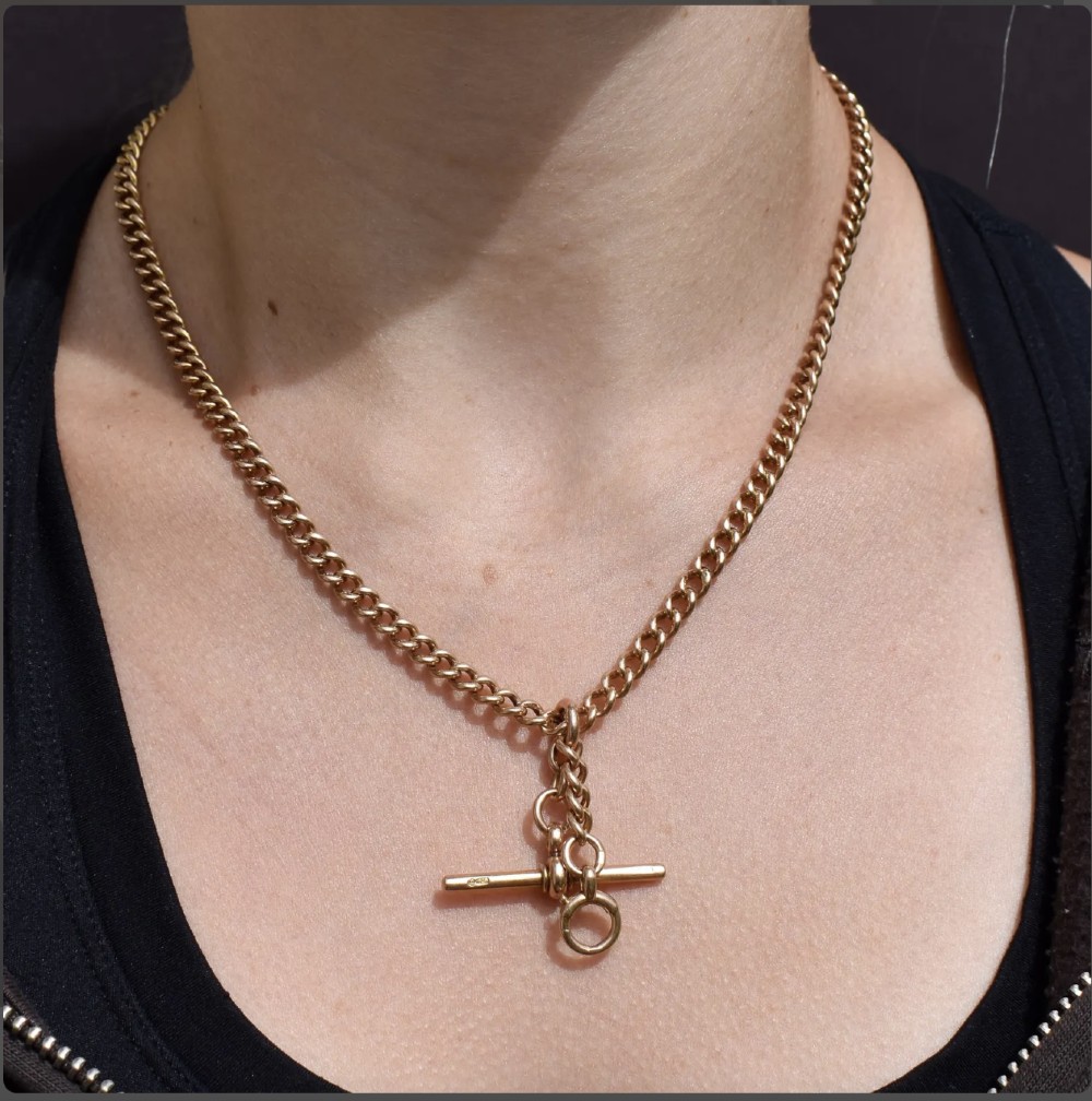 An antique 15ct yellow gold Albert chain necklace featuring curb links, a T-bar drop, a bolt ring, and a dog clip clasp. View II