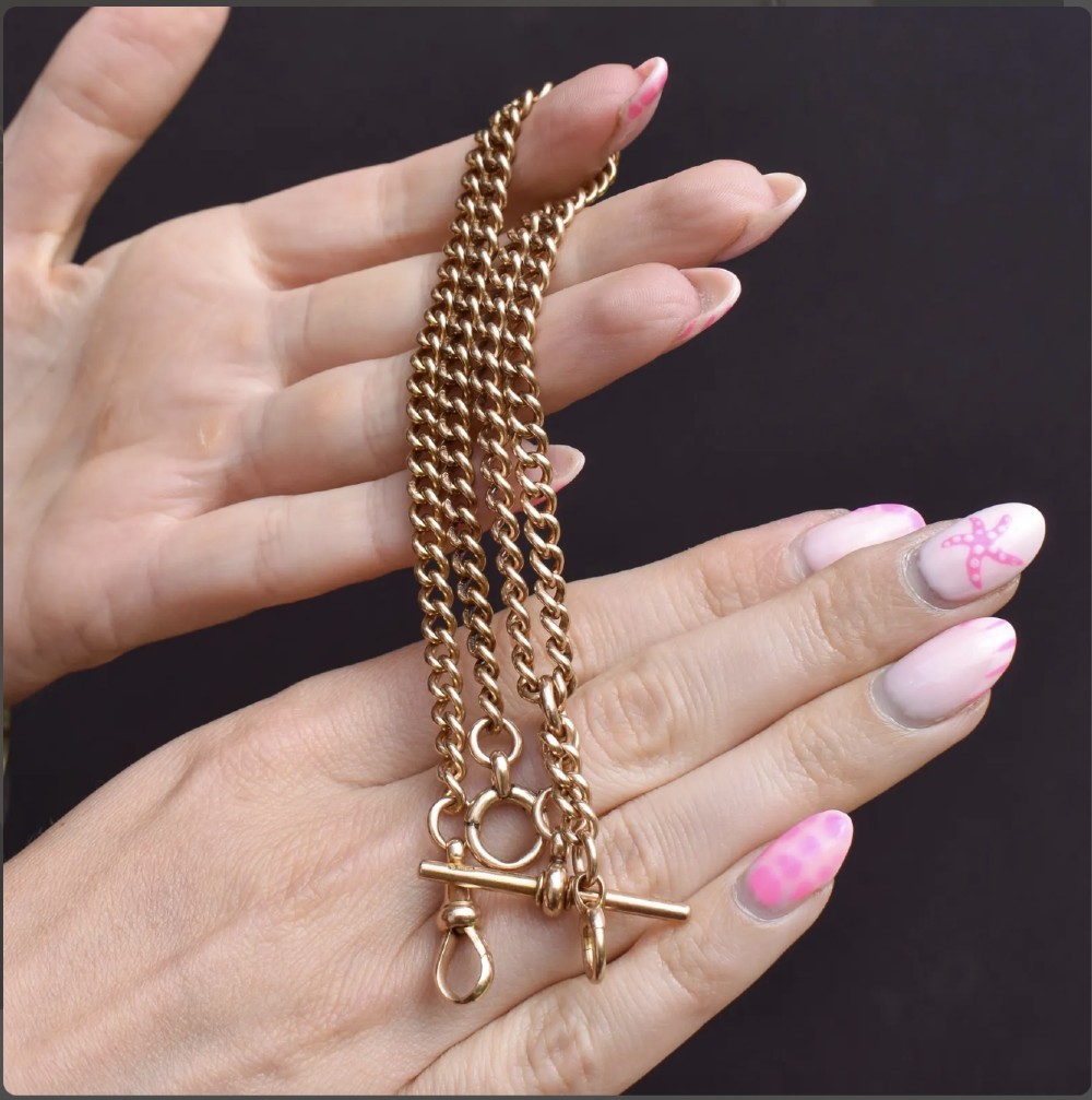 An antique 15ct yellow gold Albert chain necklace featuring curb links, a T-bar drop, a bolt ring, and a dog clip clasp. View IV